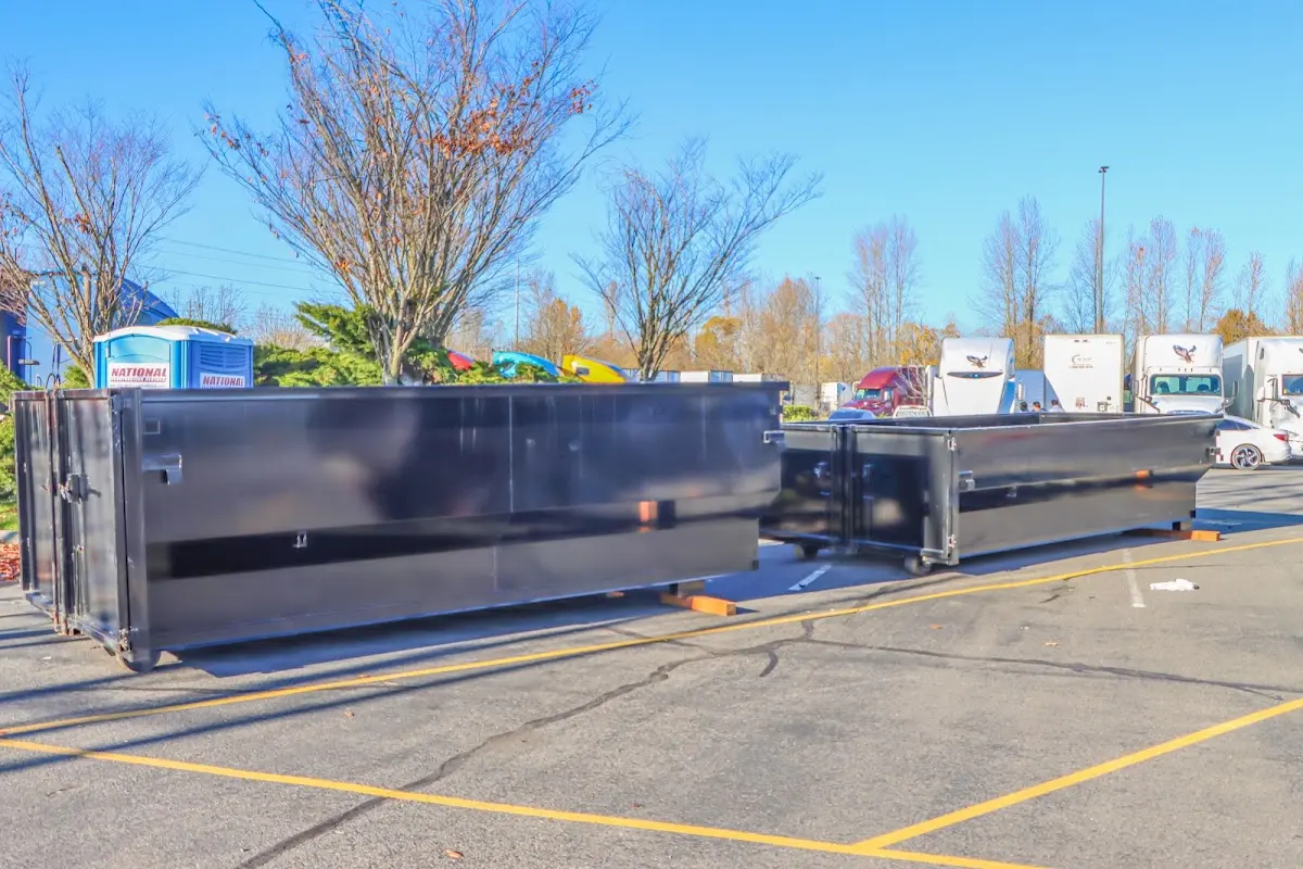 Professional dumpster rental service with roll-off container on residential driveway in Bealeton